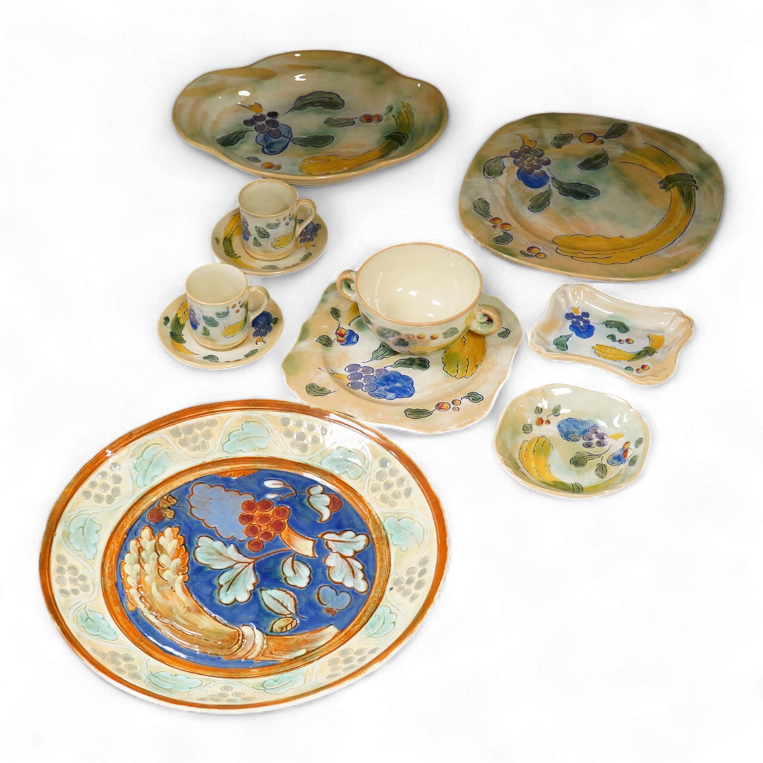 A collection of Doulton Brangwynware to include an oval dish, wall plate and two coffee cans and saucers, largest 32cm in diameter